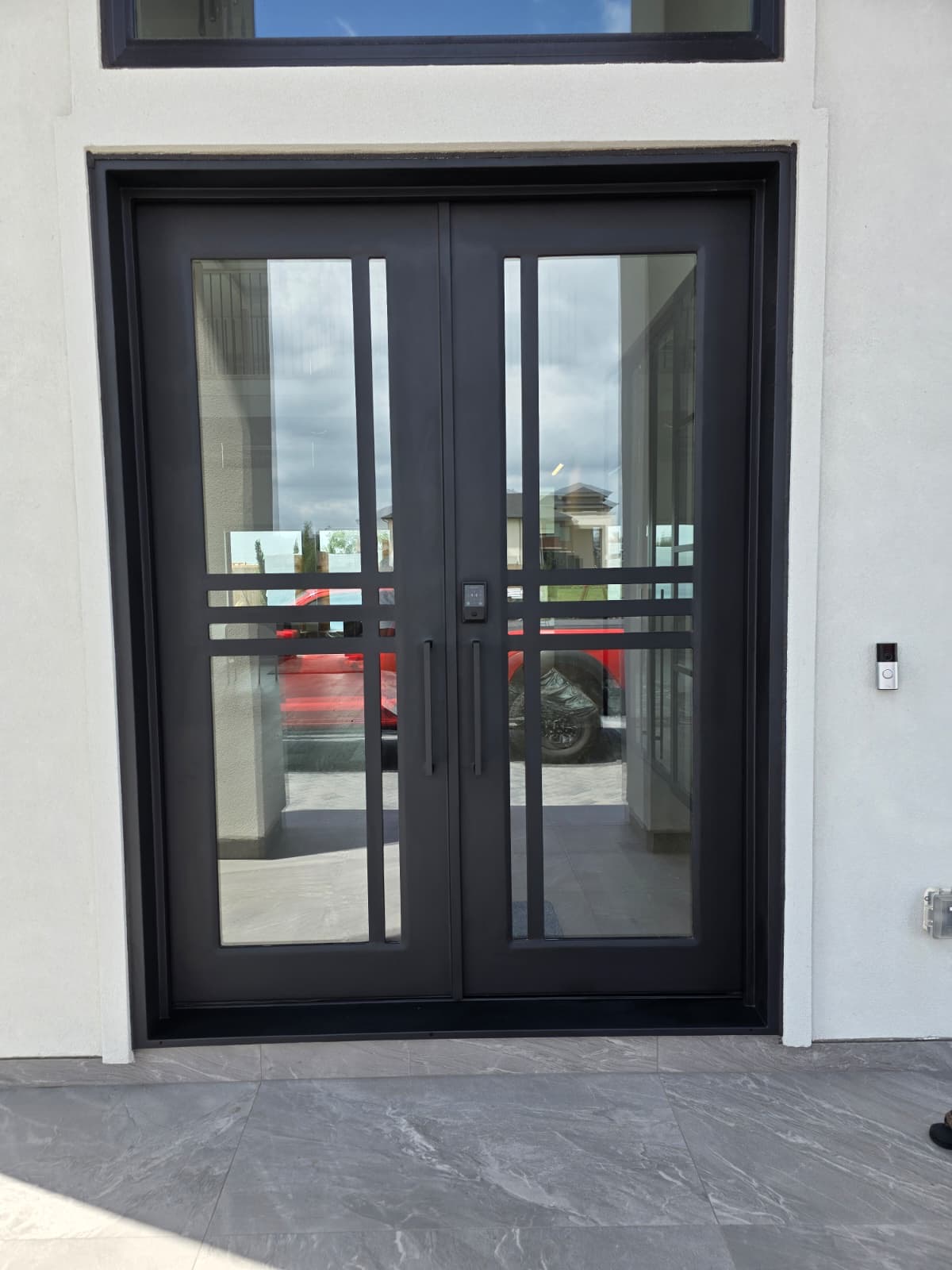 Modern iron double door with asymmetric grid pattern