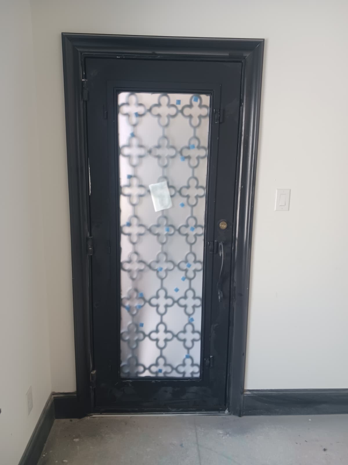 Interior view of an ornate single iron entry door