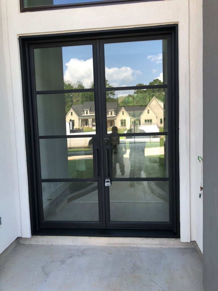 Black steel double entry door with a simple grid pattern